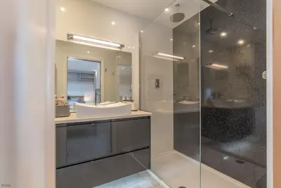 a bathroom with a sink and a glass shower at Ty-Mari in Harlech