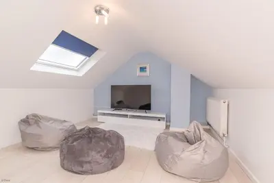 a living room with two bean bag chairs and a television at Ty-Mari in Harlech