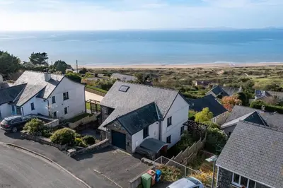 an aerial view of a house with the ocean in the background at Ty-Mari in Harlech