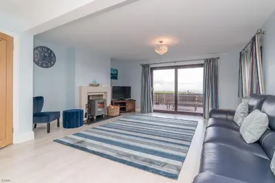 a living room with a couch and a fireplace at Ty-Mari in Harlech
