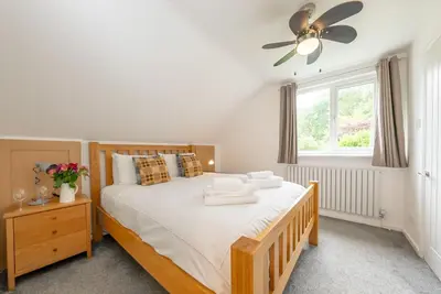 a bedroom with a bed and a ceiling fan at Erw-Fair in Arthog
