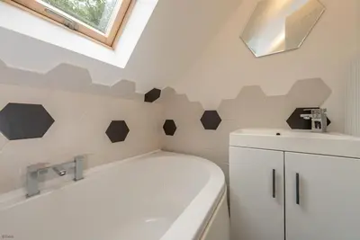 a bathroom with a toilet and a sink and a tub at Erw-Fair in Arthog