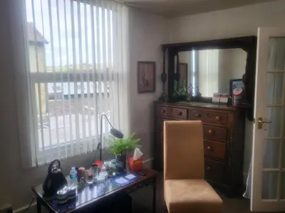 a room with a desk with a mirror and a chair at 23a High Street Knighton in Knighton