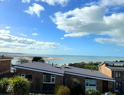 a brick house with a view of the beach at Terrace by the Tide in Aberdyfi