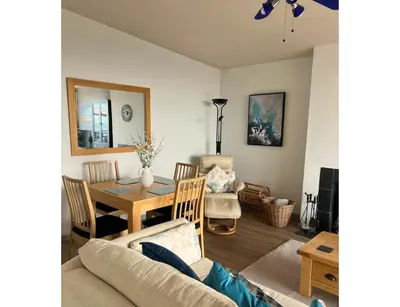 a living room with a table and a dining room at Terrace by the Tide in Aberdyfi