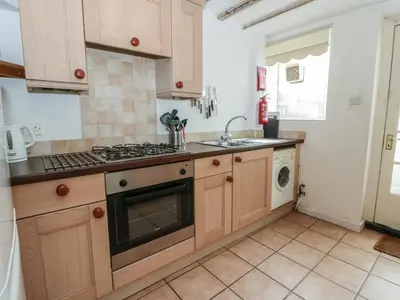 a kitchen with a sink and a stove top oven at 6 Church Lane in Llanidloes