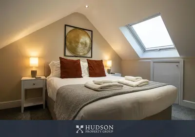 a bedroom with a bed with towels on it at Modern 5 Bedroom Home in Shrewsbury in Shrewsbury