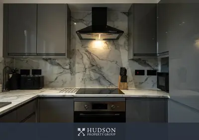 a kitchen with white marble walls and a stove at Modern 5 Bedroom Home in Shrewsbury in Shrewsbury