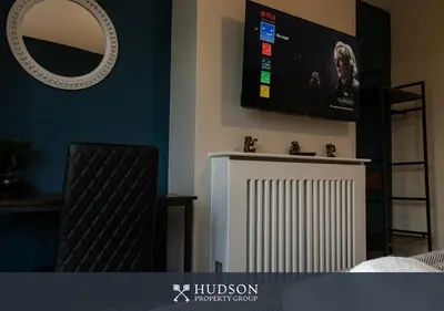 a living room with a tv and a radiator at Modern 5 Bedroom Home in Shrewsbury in Shrewsbury
