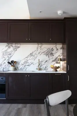 a kitchen with black cabinets and a marble counter top at Luxury Apartment in Shropshire sleeps 4 in Shrewsbury