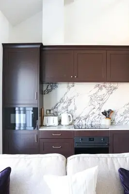 a kitchen with brown cabinets and a marble counter top at Luxury Apartment in Shropshire sleeps 4 in Shrewsbury