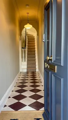 a hallway with a checkered floor and a blue door at Luxury Apartment in Shropshire sleeps 4 in Shrewsbury