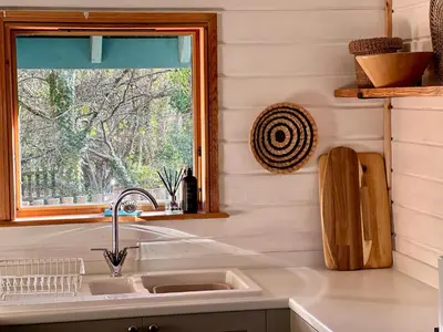 a kitchen with a sink and a window at Luxurious lodge near Barmouth in Dyffryn