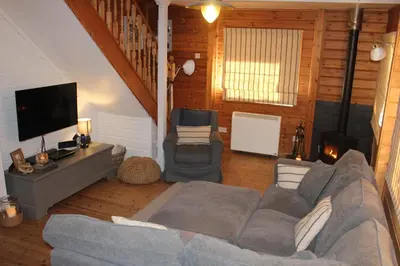 a living room with a couch and a tv at Luxurious lodge near Barmouth in Dyffryn