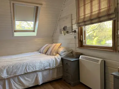 a small bedroom with a bed and a window at Luxurious lodge near Barmouth in Dyffryn
