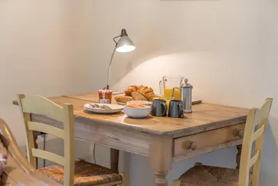 a wooden table with breakfast food on it at Deer-Park-Lodge in Llanfachreth