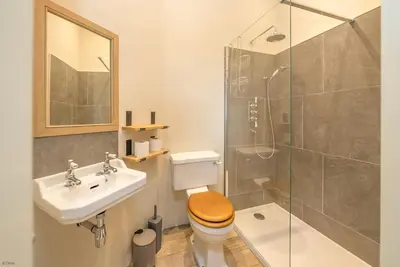 a bathroom with a toilet and a sink and a shower at Deer-Park-Lodge in Llanfachreth