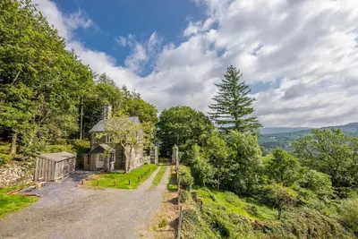 an old house on the side of a road at Deer-Park-Lodge in Llanfachreth