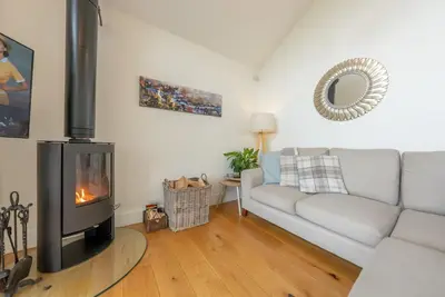 a living room with a couch and a fireplace at Llety-Hiraeth in Montgomery