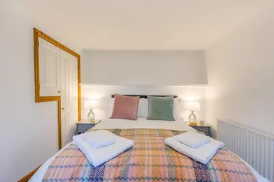 a bedroom with a large bed with two pillows at 3 Bed in Rhydyfelin oc-c34178 in Rhyd-y-felin