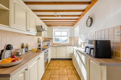 a kitchen with white cabinets and a counter top at 3 Bed in Rhydyfelin oc-c34178 in Rhyd-y-felin