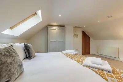 a bedroom with a large white bed with a skylight at 3 Bed in Rhydyfelin oc-y34179 in Rhyd-y-felin