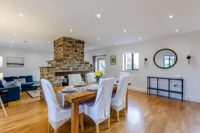 a dining room and living room with a table and chairs at 3 Bed in Rhydyfelin oc-y34179 in Rhyd-y-felin
