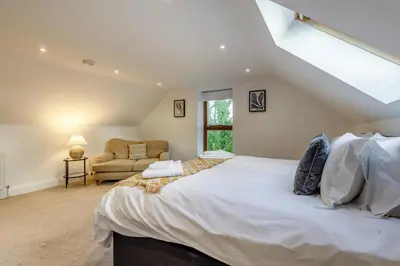 a bedroom with a large white bed and a couch at 3 Bed in Rhydyfelin oc-y34179 in Rhyd-y-felin