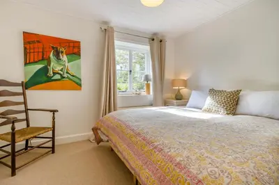 a bedroom with a bed and a painting of a dog at 3 Bed in Newton St. Margarets oc-o33367 in Saint Margaret