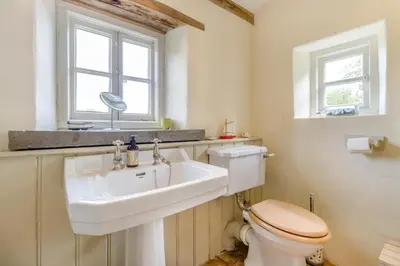 a bathroom with a sink and a toilet and a window at 3 Bed in Newton St. Margarets oc-o33367 in Saint Margaret