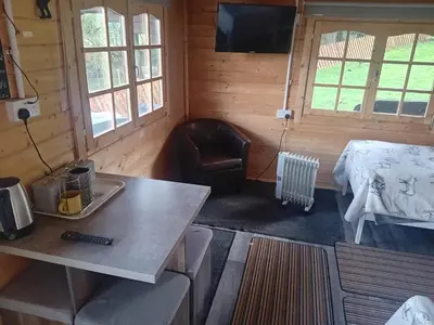 a room with a bed and a table in a room at Moonlight View in Newtown