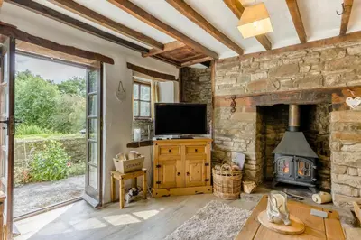 a living room with a fireplace and a tv at 2 Bed in Llandefalle oc-n32991 in Llandefalle
