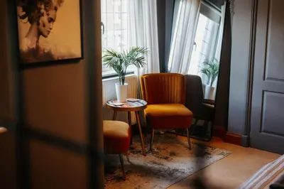 a room with a table and a chair and a window at Cherry Tree House in Shrewsbury