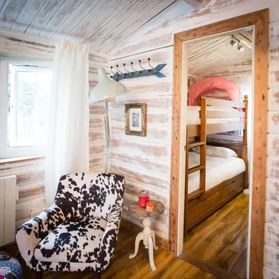 a room with a chair and a bunk bed at Wunder Lodge - Snowdonia Log Cabin in Trawsfynydd