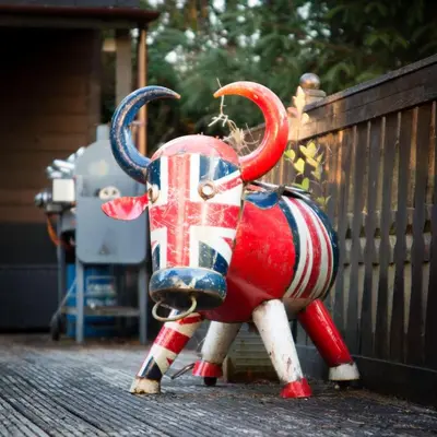 a statue of a bull dressed in the british flag at Wunder Lodge - Snowdonia Log Cabin in Trawsfynydd
