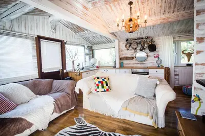 a living room with a couch and a chandelier at Wunder Lodge - Snowdonia Log Cabin in Trawsfynydd