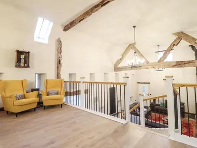 a living room with two chairs and a couch at Godre'r Gyrn, Plas Moelfre Hall Barns in Oswestry