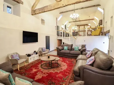 a large living room with couches and a tv at Godre'r Gyrn, Plas Moelfre Hall Barns in Oswestry