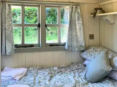 a bedroom with a bed and two windows at Bryn Gwyn - Ukc7801 in Shrewsbury