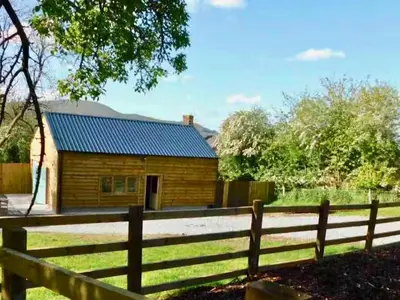 a wooden house with a fence in front of it at The Orchard - Ukc7804 in Shrewsbury