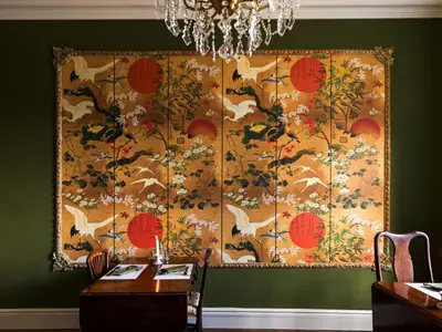 a tapestry hanging on a wall in a dining room at Belmont House in Hay-on-Wye