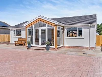 a white house with a conservatory with windows at 3 Bed in Brecon oc-92341 in Brecon