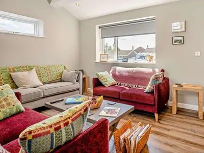 a living room with two couches and a table at 3 Bed in Brecon oc-92341 in Brecon