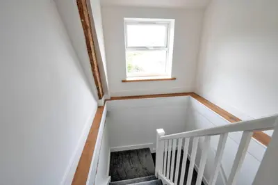 a white staircase with a window in a room at Finest Retreats - Brecon House in Builth Wells