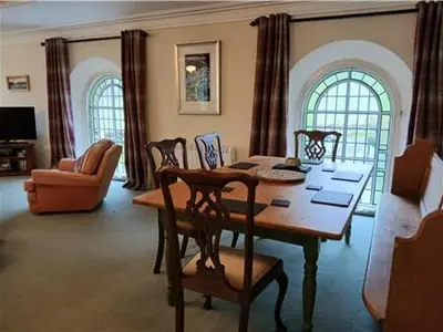 a living room with a wooden table and chairs at Capel Pennal in Pennal