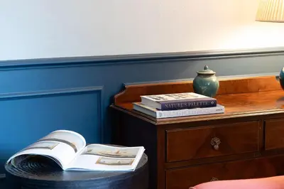 a stack of books sitting on top of a dresser at Wyvern House in Alberbury