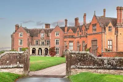 an old mansion with a gate in front of it at Wyvern House in Alberbury