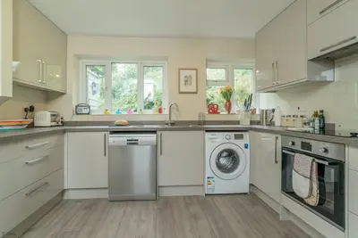 a kitchen with a washing machine and a washer at Hendre-Llangwm in Llangwm