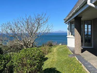 a house with a view of the ocean at Murmur Y Don in Harlech