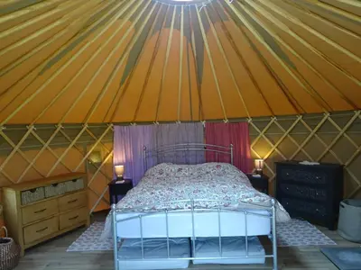 a bedroom in a yurt with a bed in it at Willey Lane Farm in Lingen